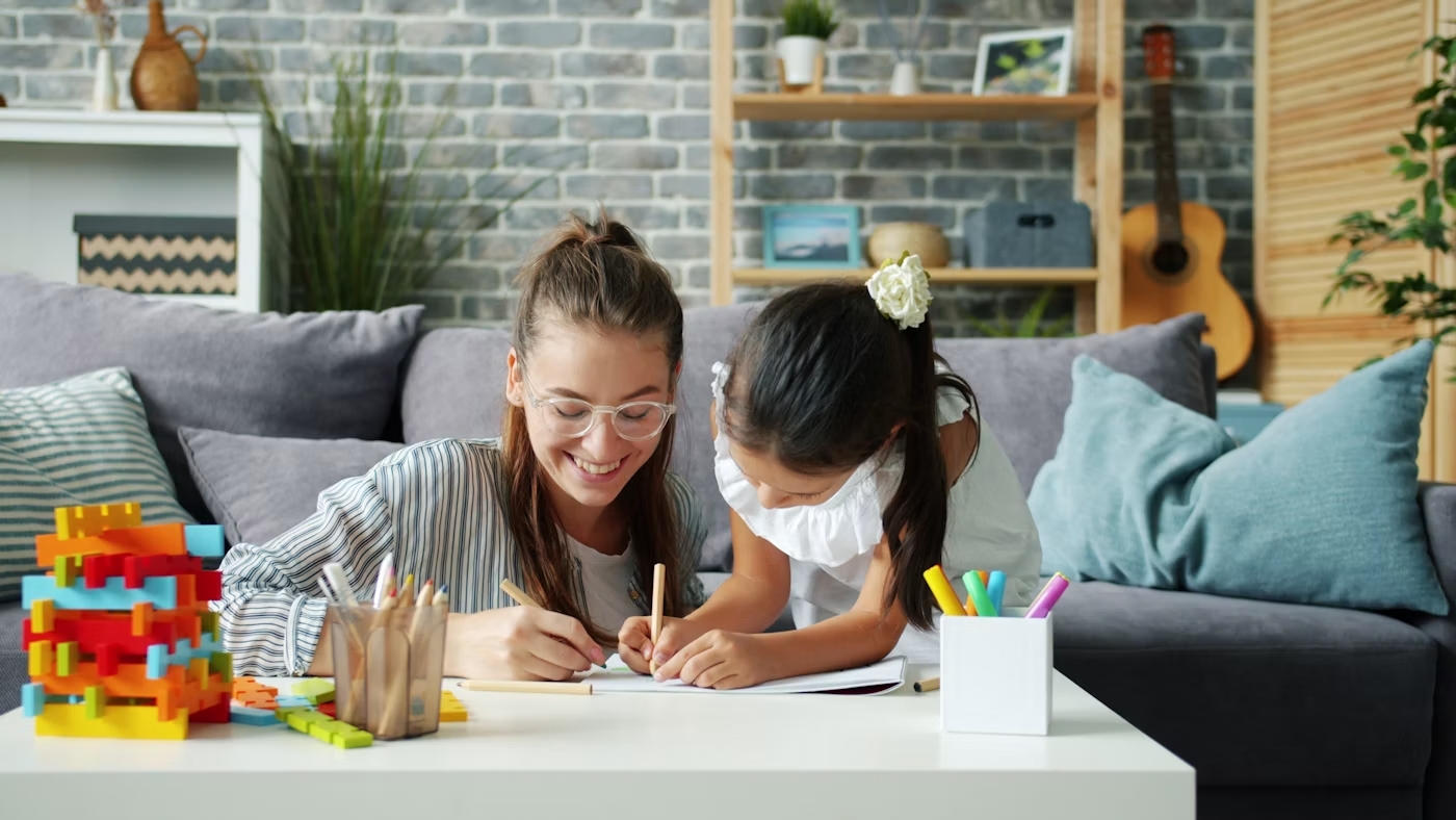 Mother and child drawing together during a creative learning activity